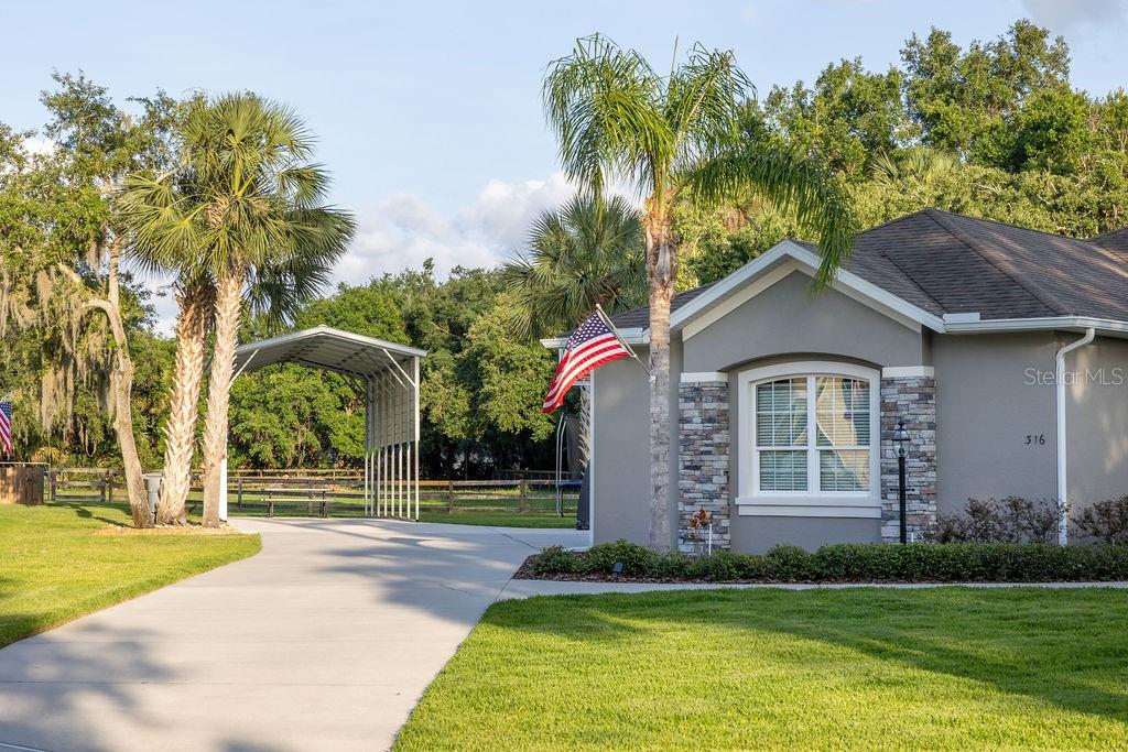 316 Old Mill Road Deltona, FL 32725 - Photo 53 of 64 a front view of a house with a garden