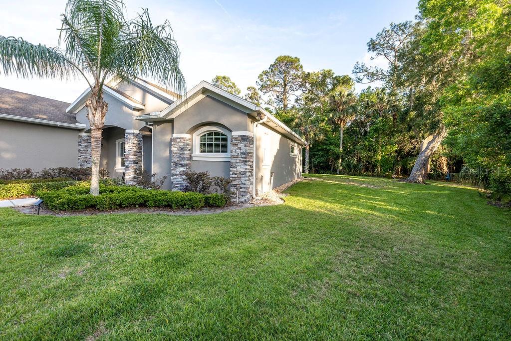 316 Old Mill Road Deltona, FL 32725 - Photo 54 of 64 a front view of a house with a garden