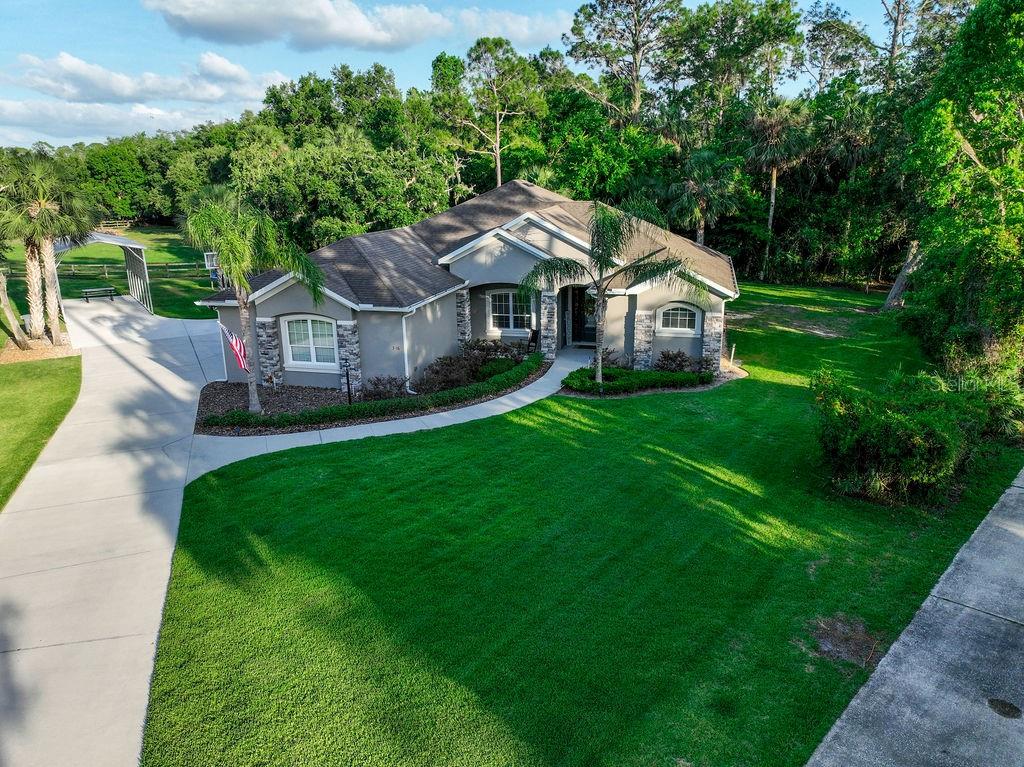 316 Old Mill Road Deltona, FL 32725 - Photo 60 of 64 a aerial view of a house with garden