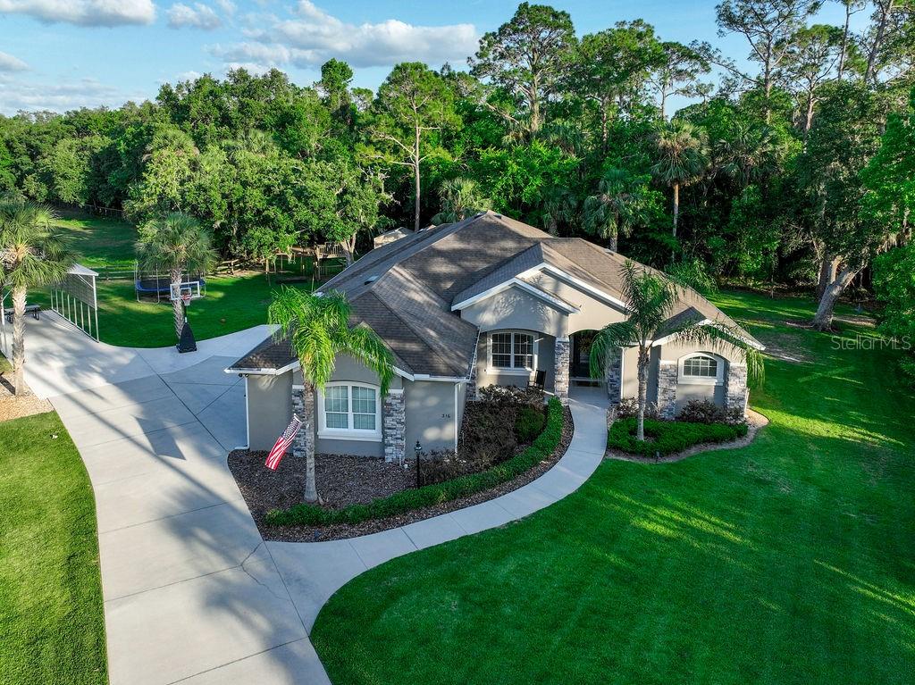 316 Old Mill Road Deltona, FL 32725 - Photo 63 of 64 a view of a house with backyard and porch