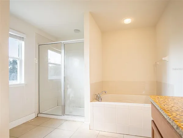 a bathroom with a tub shower and a sink