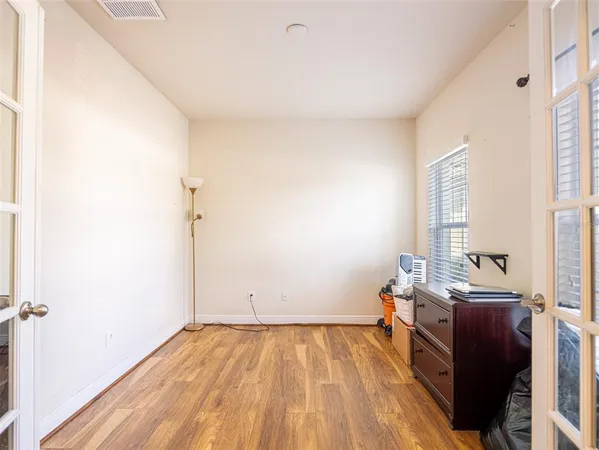 a view of a room with workspace and wooden floor