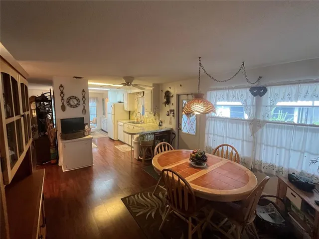 a dining room with furniture and wooden floor