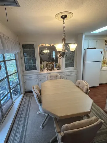 a living room with a balcony furniture and a chandelier