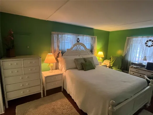 a bedroom with a bed and a dresser