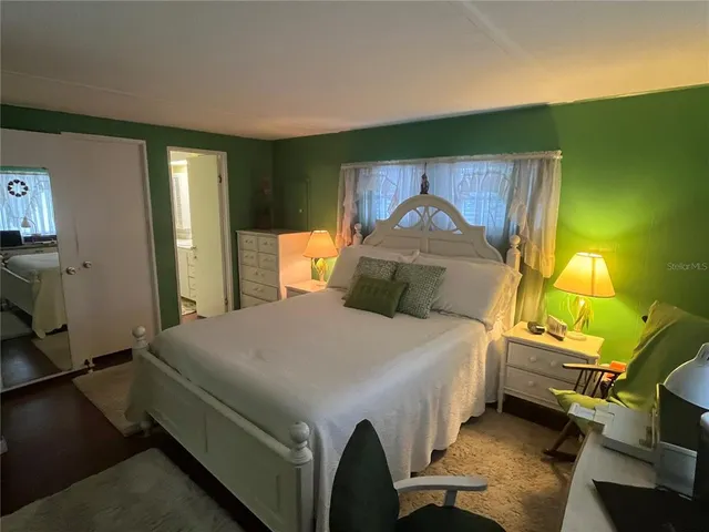 a bedroom with a bed and a dresser