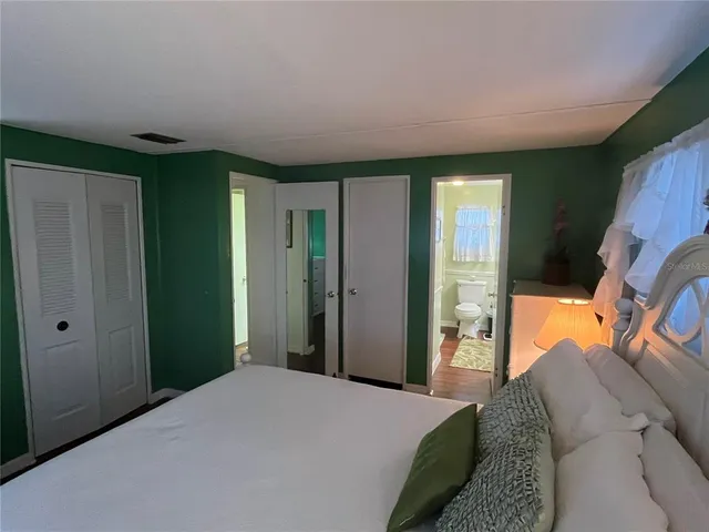 a bedroom with a bed and a mirror