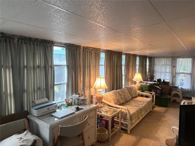 a living room with furniture and large windows