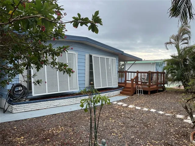a backyard of a house with table and chairs