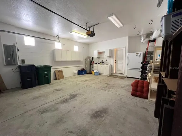 an empty room with fan and entrance