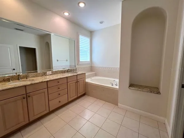 a view of a patio with table and chairs and a large tree