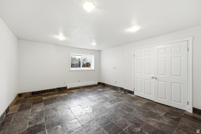 3535 Homestead Road Park City, UT 84098 - Photo 57 of 81 Spacious room featuring slate-style tile flooring, white walls, and a window providing natural light