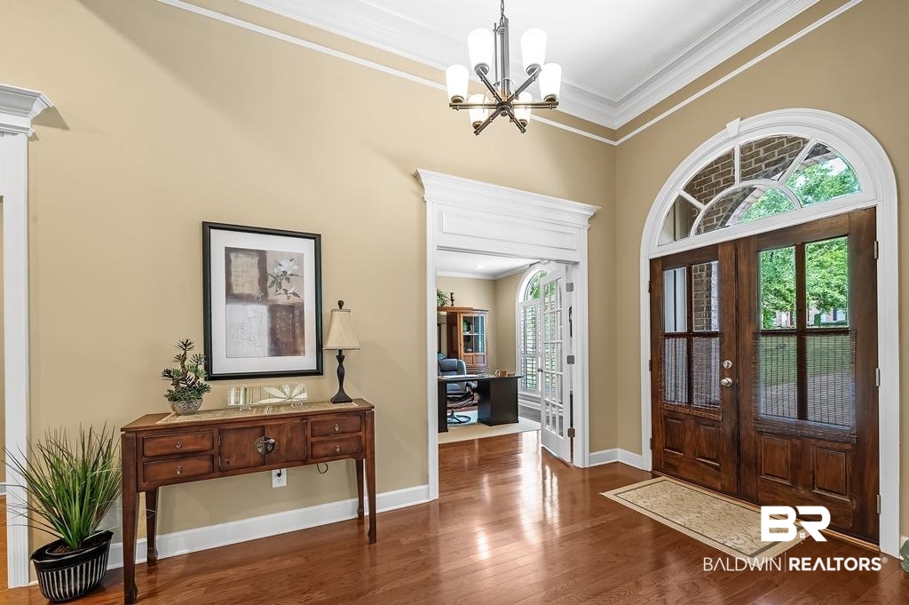 29976 Dolive Ridge Daphne, AL 36527 - Photo 9 of 58 Foyer entrance featuring dark hardwood / wood-style floors, french doors, a notable chandelier, and ornamental molding