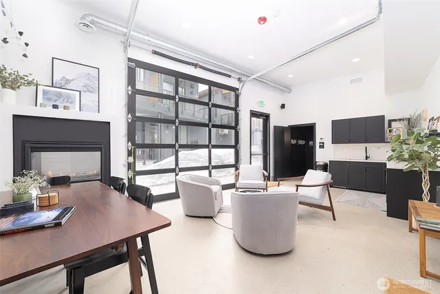 a living room with furniture a large window and a flat screen tv