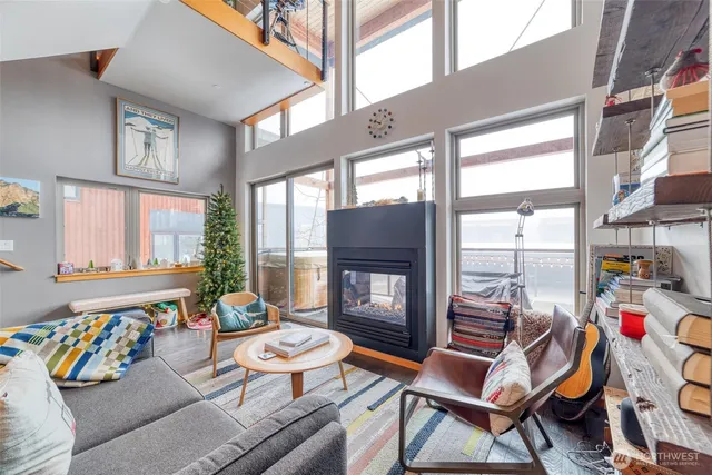 a living room with furniture and a floor to ceiling window