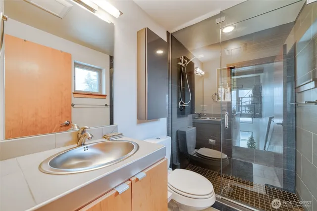 a bathroom with a toilet sink shower and mirror