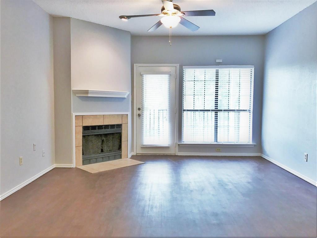 wooden floor fireplace and natural light in room