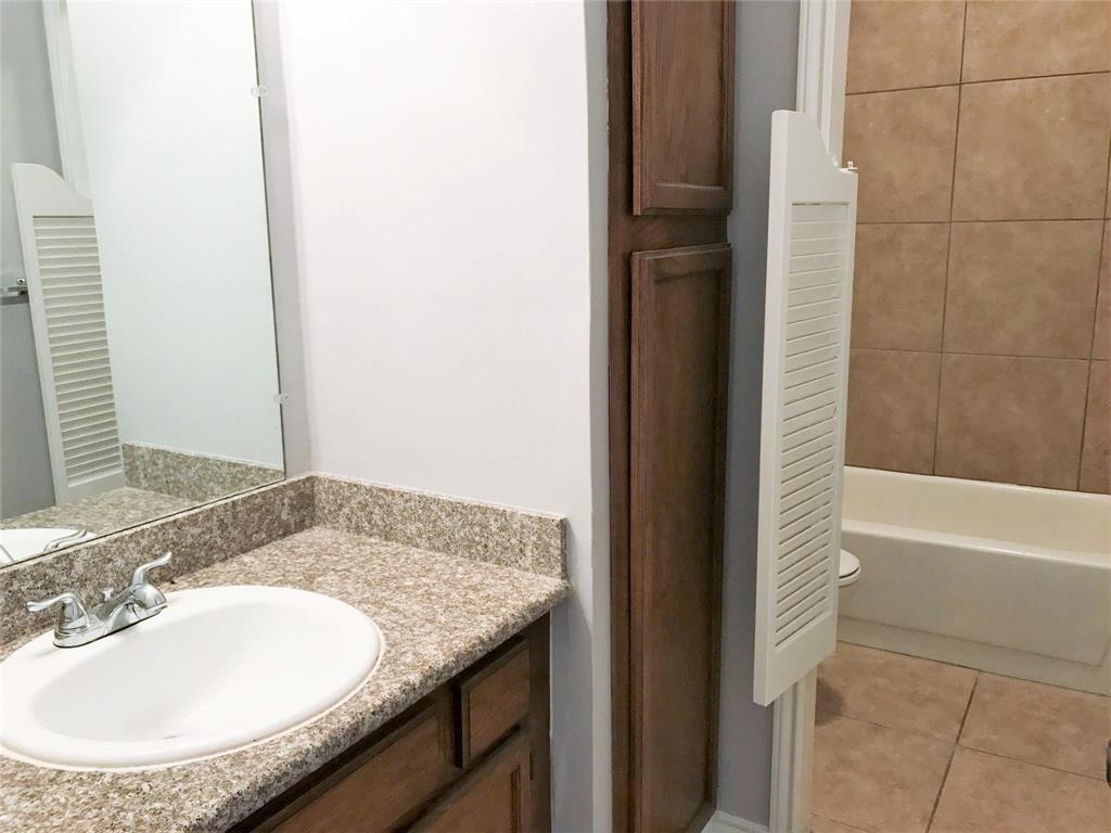 9601 Forest Lane, Unit 1313 Dallas, TX 75243 - Photo 12 of 19 a bathroom with a granite countertop sink and a mirror