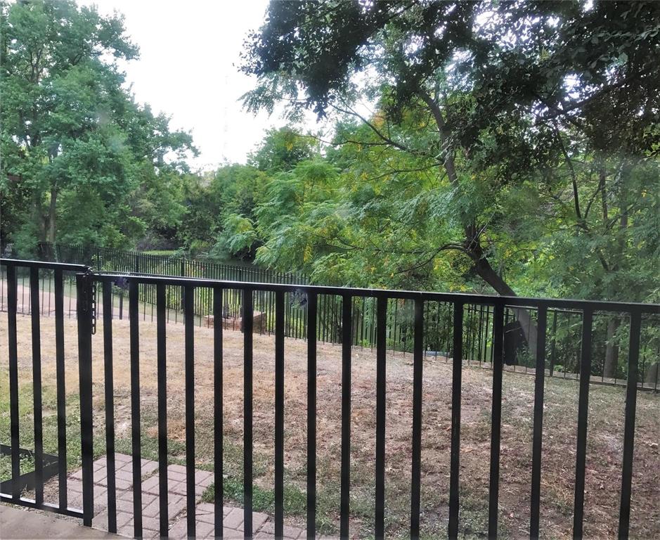 9601 Forest Lane, Unit 1313 Dallas, TX 75243 - Photo 13 of 19 a balcony with wooden floor and trees