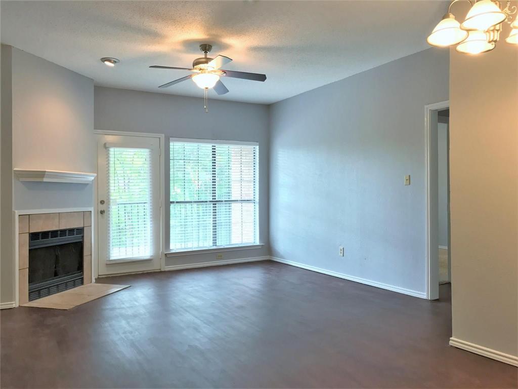 9601 Forest Lane, Unit 1313 Dallas, TX 75243 - Photo 18 of 19 a view of an empty room with a fireplace and a window