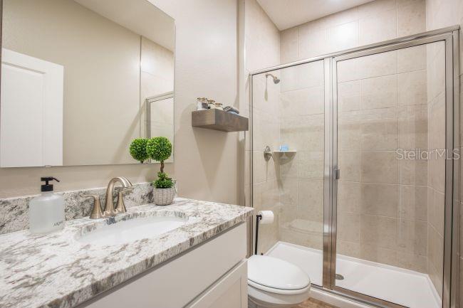 16492 Crane Road Weeki Wachee, FL 34614 - Photo 14 of 24 a bathroom with a granite countertop sink toilet and shower