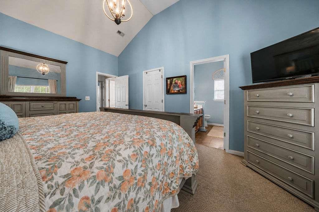 45 Highlander Trail Southwest Rome, GA 30165 - Photo 23 of 32 a bedroom with a bed and a flat tv screen on dresser