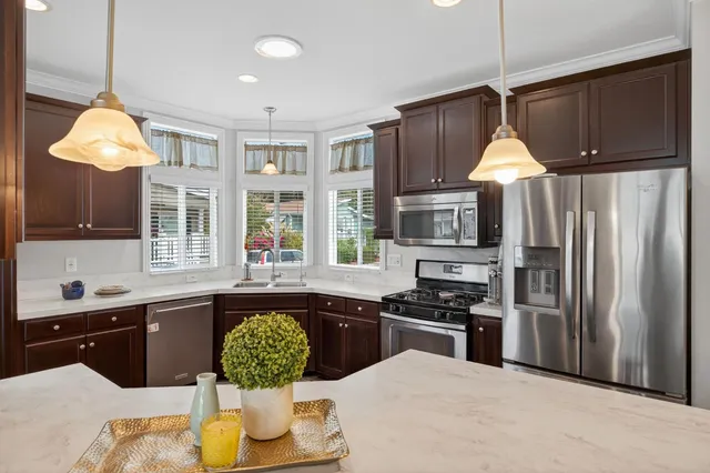a kitchen with a sink stove and window