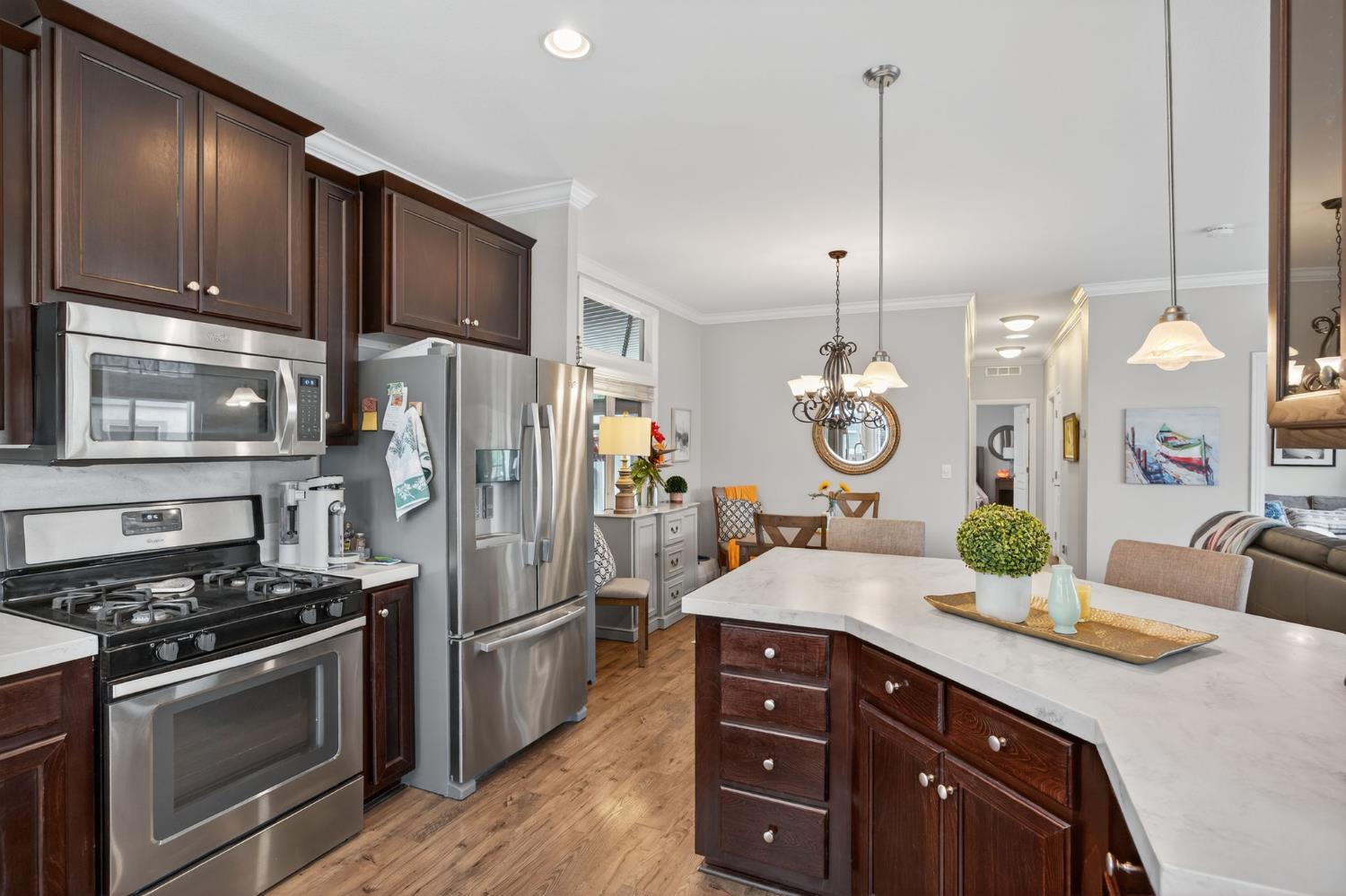 1885 Maricopa Highway, Unit 1 Ojai, CA 93023 - Photo 20 of 36 a kitchen with stainless steel appliances granite countertop a refrigerator a stove and a wooden floors