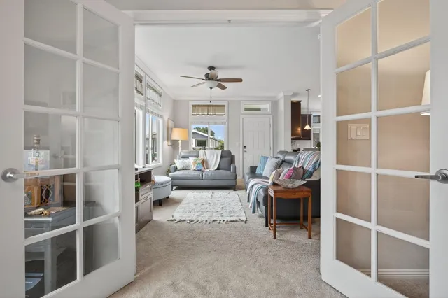 a spacious bedroom with a bed and a chandelier
