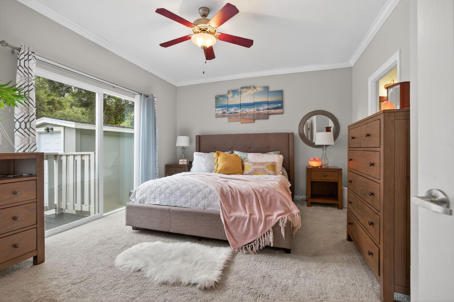 1885 Maricopa Highway, Unit 1 Ojai, CA 93023 - Photo 24 of 36 a spacious bedroom with a bed and a chandelier