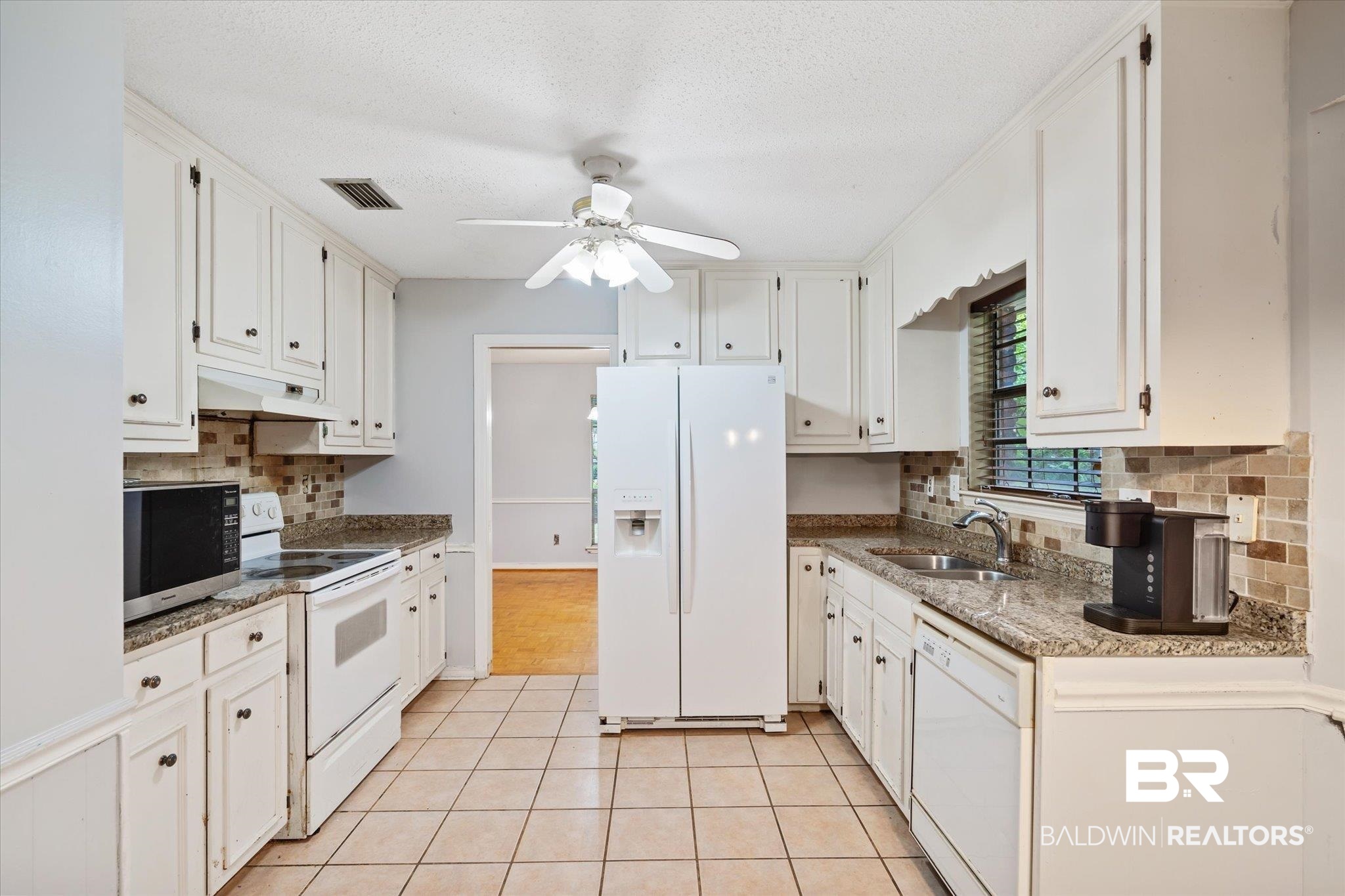 6657 Hounds Run South Mobile, AL 36608 - Photo 4 of 20 Kitchen featuring white appliances, light tile patterned floors, sink, ceiling fan, and white cabinets