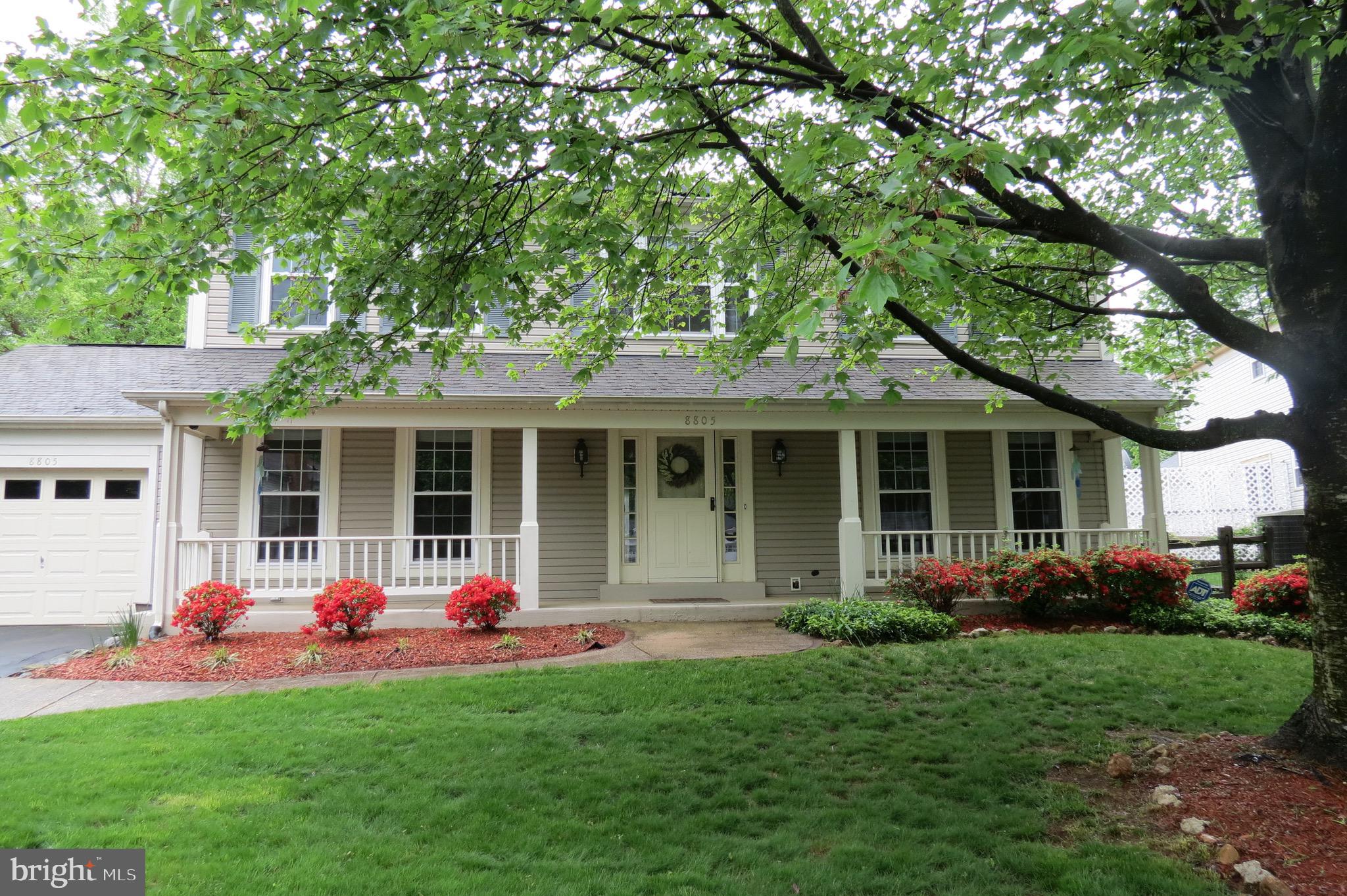 a front view of a house with a garden and porch