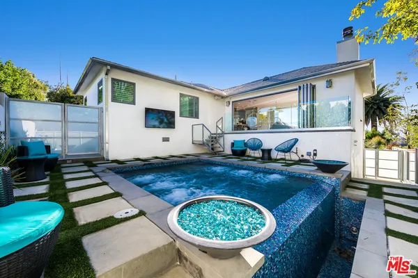 a living room with furniture and a swimming pool