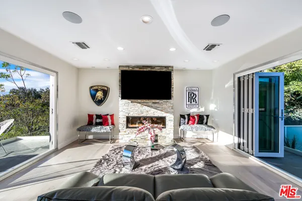 a living room with fireplace furniture and a flat screen tv