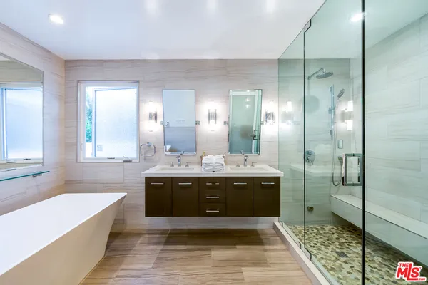 a view of bathroom with bathtub and shower