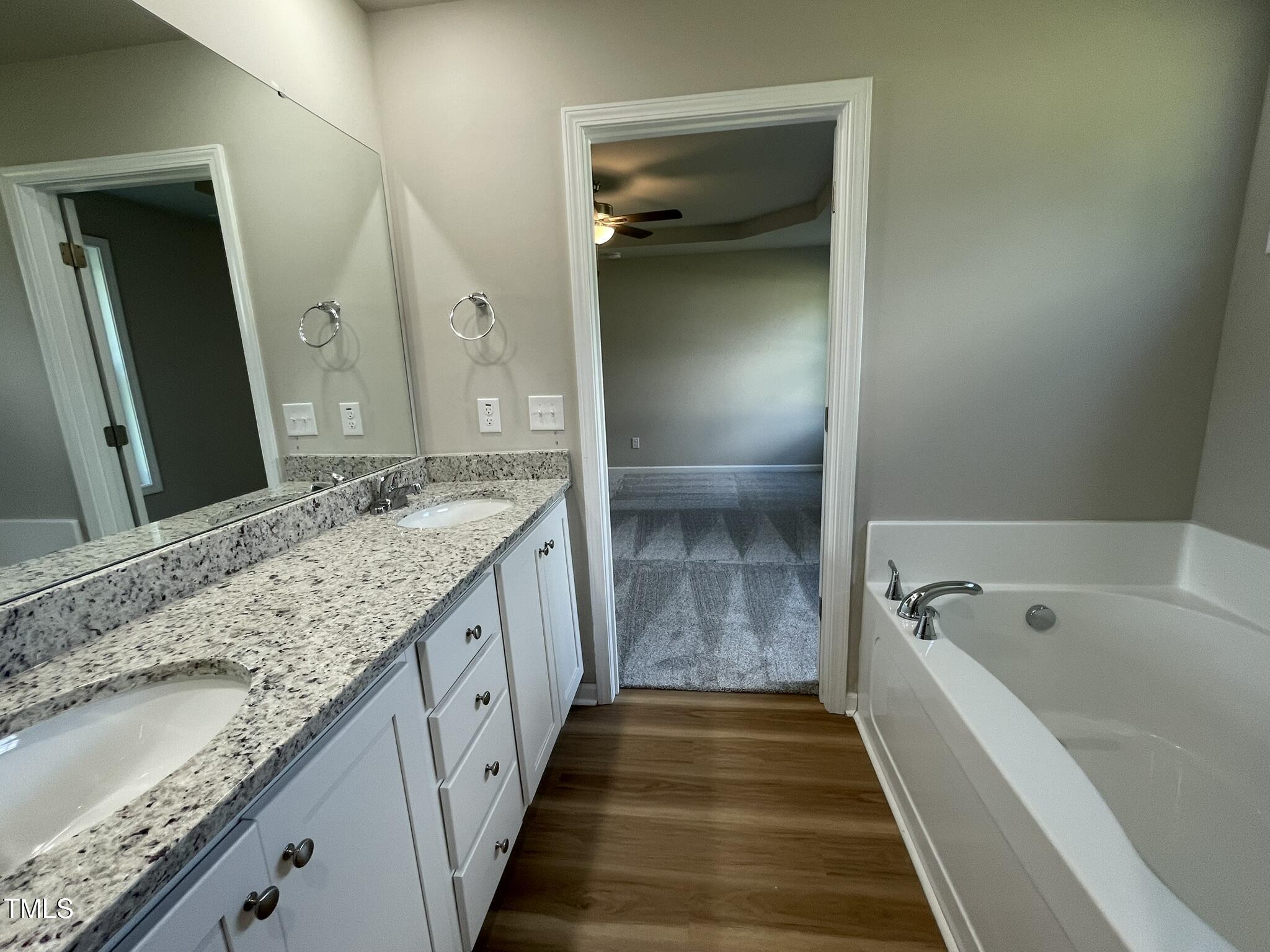 168 Oakfield Trce Drive Four Oaks, NC 27524 - Photo 11 of 19 a bathroom with a granite countertop tub sink and mirror