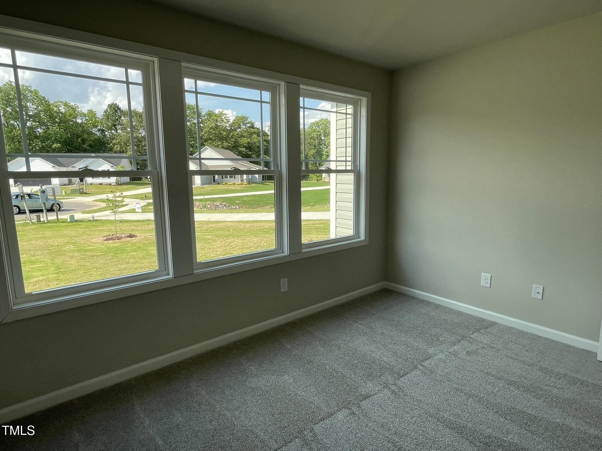 168 Oakfield Trce Drive Four Oaks, NC 27524 - Photo 14 of 19 a view of an empty room with wooden floor and a window