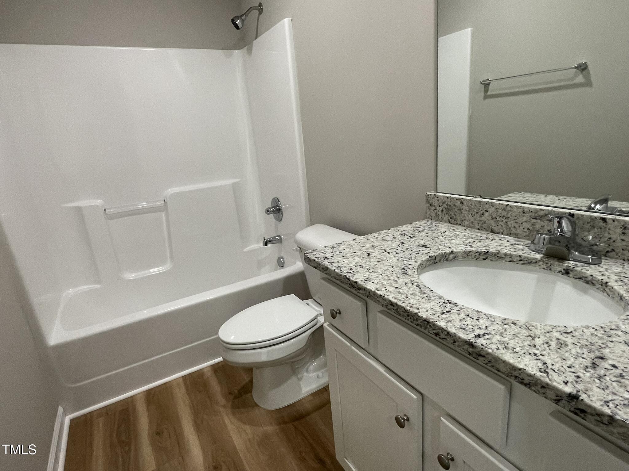 168 Oakfield Trce Drive Four Oaks, NC 27524 - Photo 16 of 19 a bathroom with a granite countertop sink toilet and shower