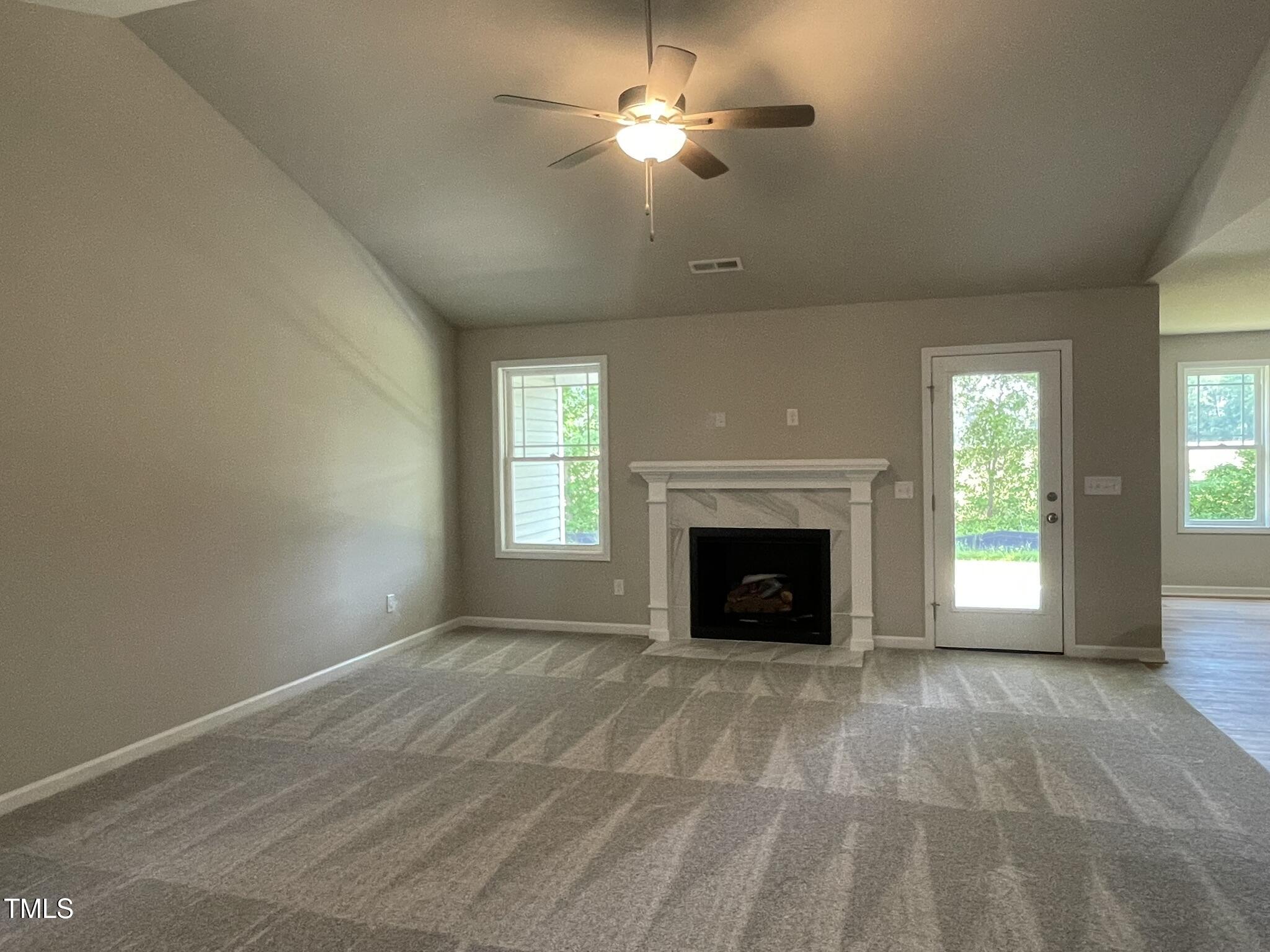 168 Oakfield Trce Drive Four Oaks, NC 27524 - Photo 2 of 19 a view of empty room with fireplace and fan