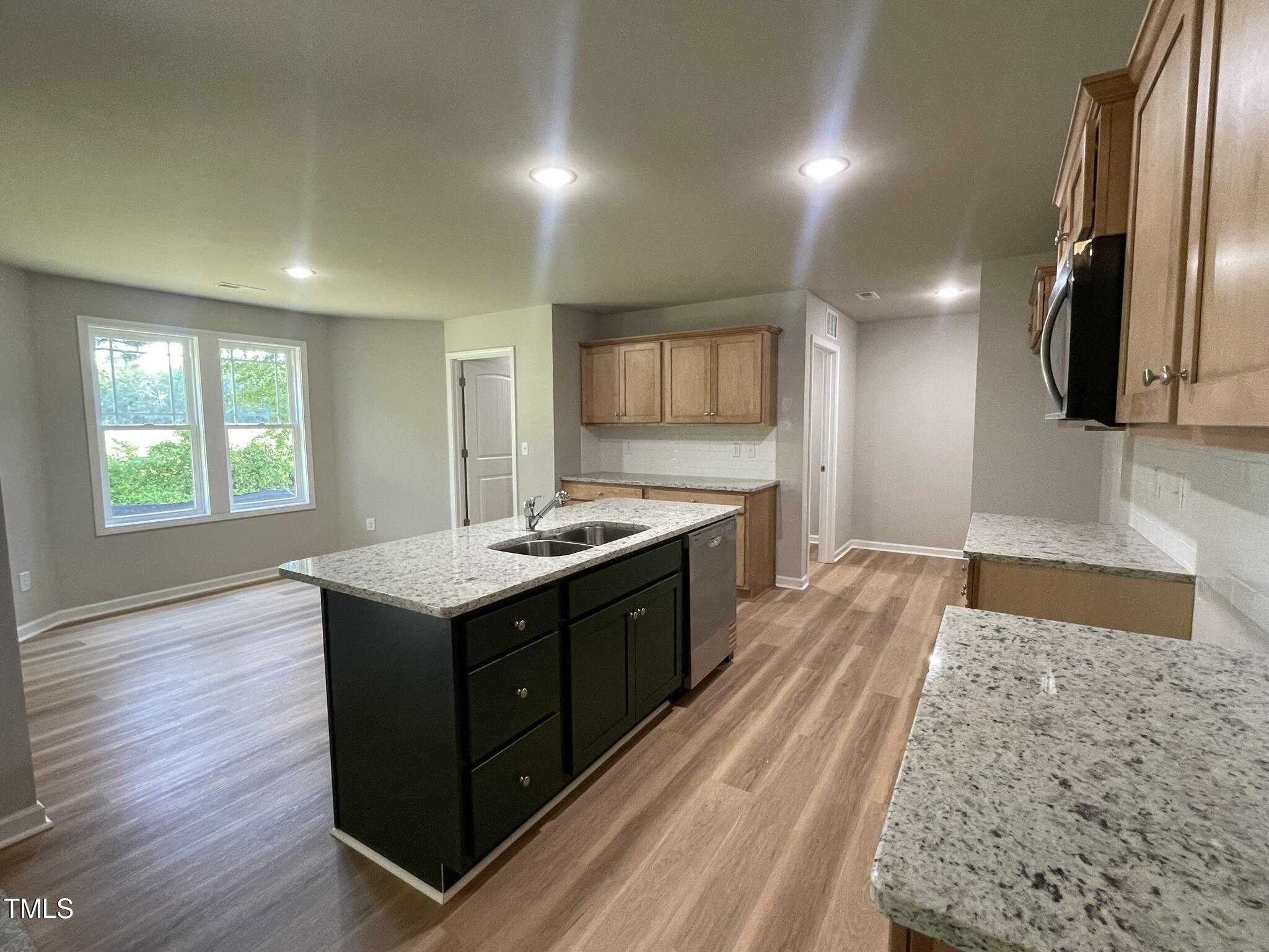 168 Oakfield Trce Drive Four Oaks, NC 27524 - Photo 3 of 19 a large kitchen with stainless steel appliances granite countertop a sink stove and refrigerator