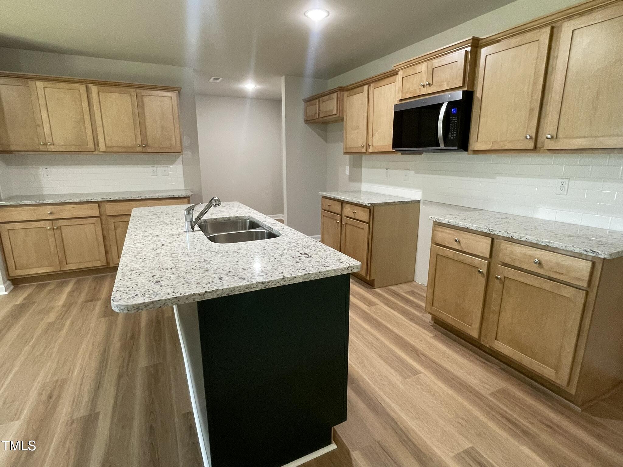 168 Oakfield Trce Drive Four Oaks, NC 27524 - Photo 4 of 19 a kitchen with stainless steel appliances granite countertop a sink stove and microwave