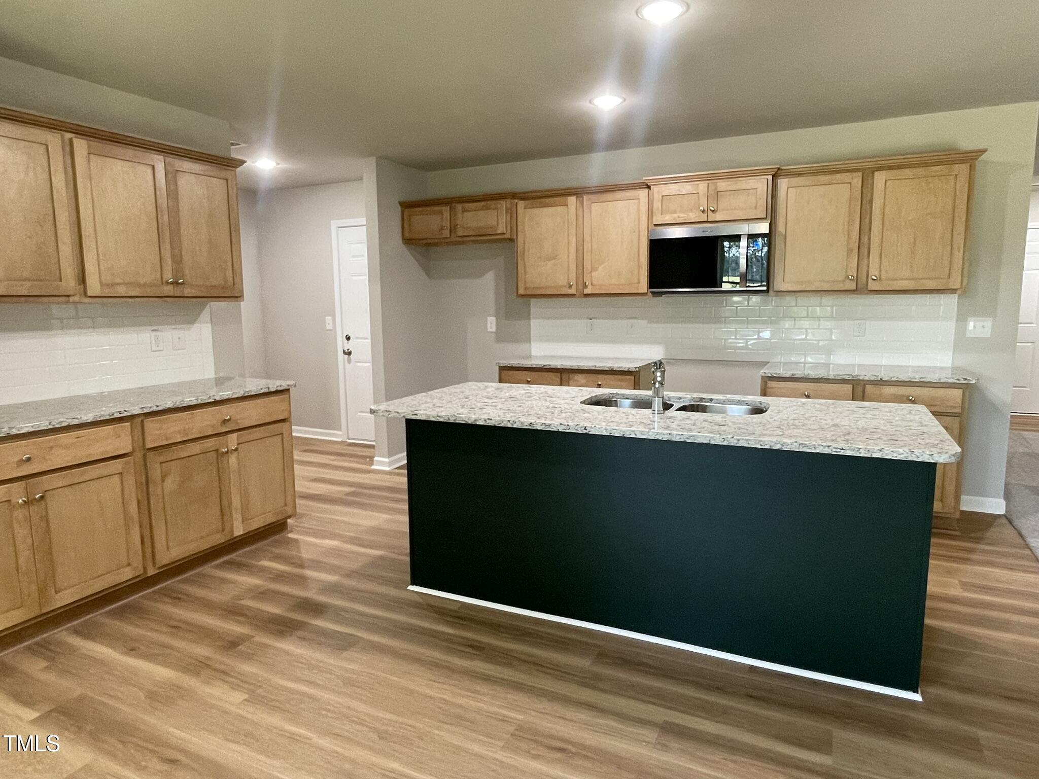 168 Oakfield Trce Drive Four Oaks, NC 27524 - Photo 5 of 19 a kitchen with a sink cabinets and wooden floor