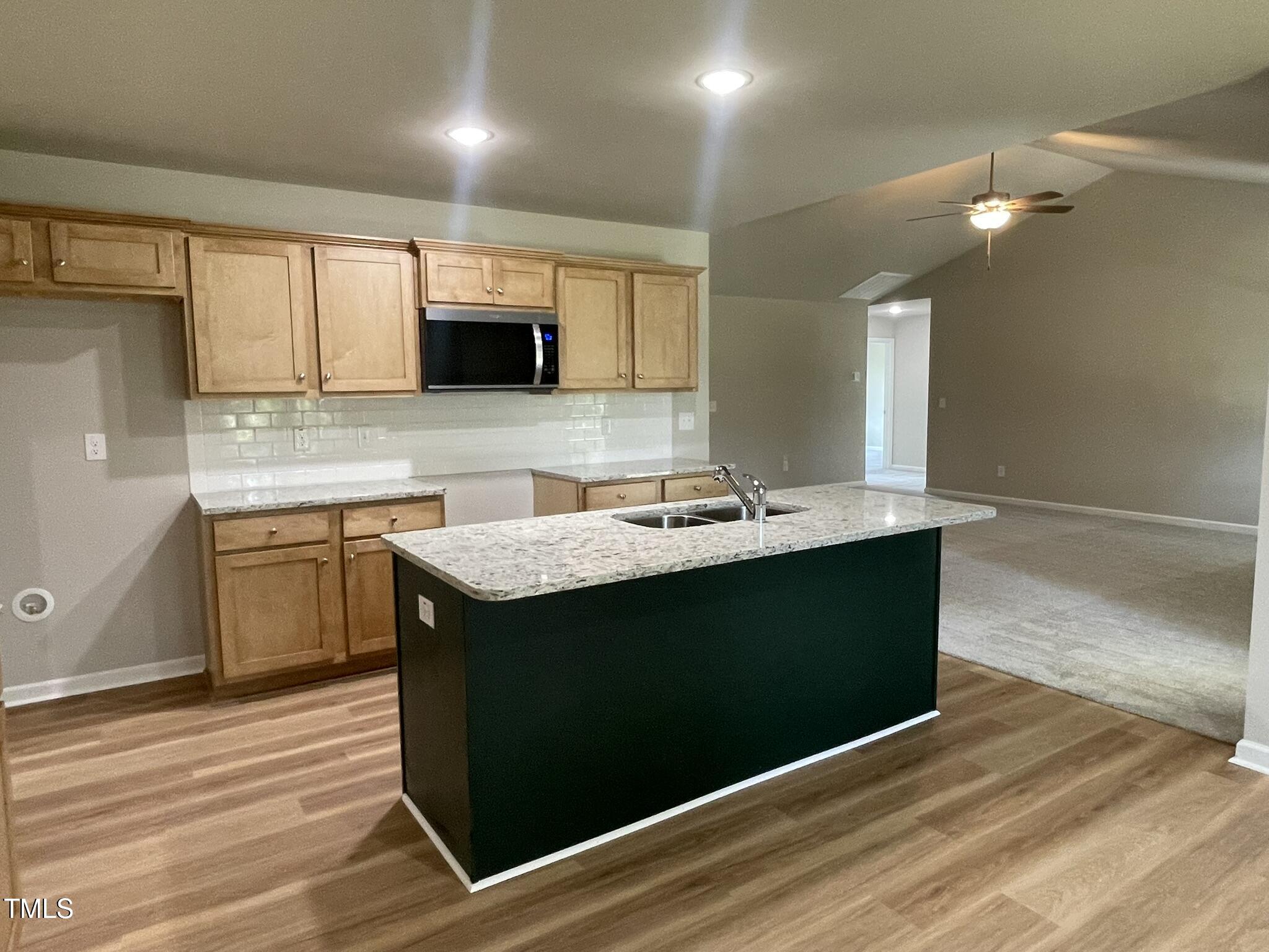 168 Oakfield Trce Drive Four Oaks, NC 27524 - Photo 7 of 19 a kitchen with a sink and a microwave