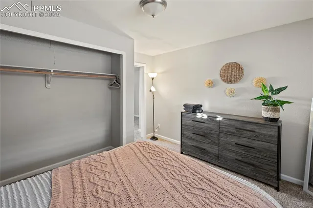 a bedroom with a dresser and a chandelier