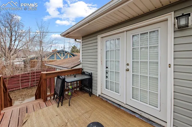 a view of balcony with two chairs and a barbeque