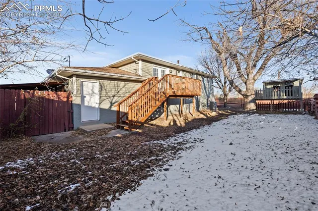 a view of a backyard with a wooden fence