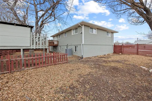 a view of a house with wooden fence