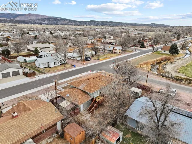 an aerial view of a residential houses with outdoor space