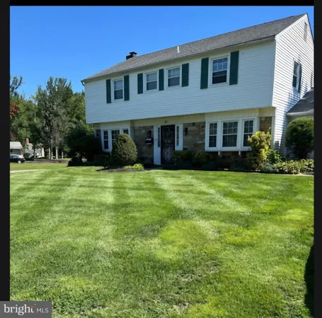 a view of house with yard and green space