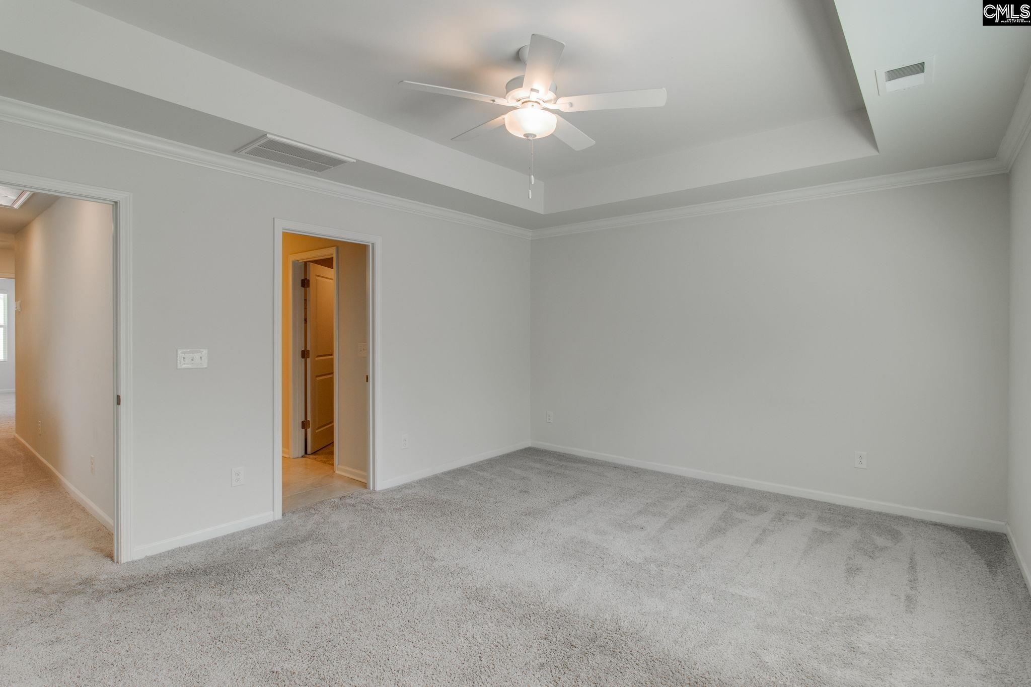 312 Reedmace Court Lexington, SC 29072 - Photo 16 of 29 an empty room with a ceiling fan and a window